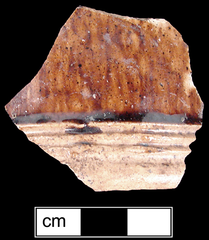 Manganese Mottled small mug or tankard with cordoning/wheel-turned grooves at the foot band.  The foot and base of the vessel are unglazed - collected by George L. Miller in 1986 in Staffordshire in Hanley.  Cannot be attributed to a specific pottery. 